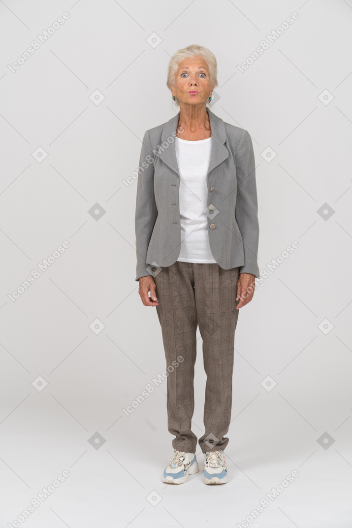 Front view of an old woman in suit making faces