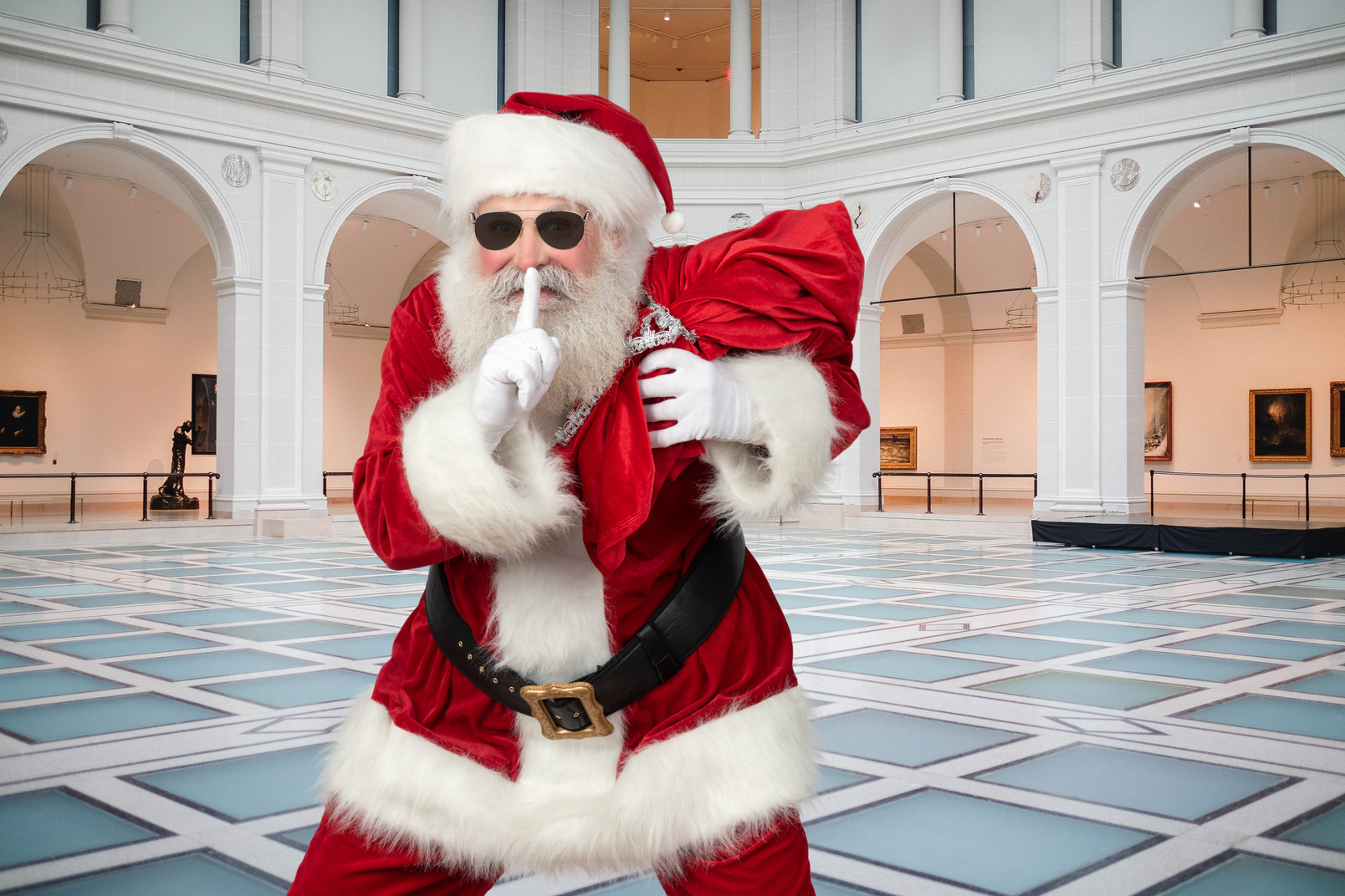Cool looking santa claus showing silence sign