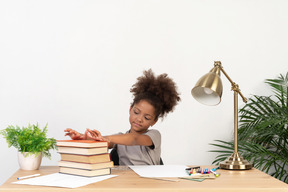 Good looking cute girl with books at the table