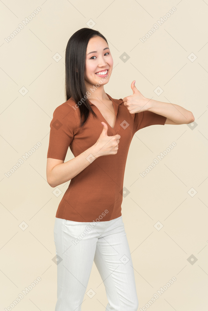 Young asian woman showing thumbs up