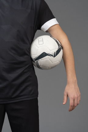 Close-up of a soccer player holding a ball