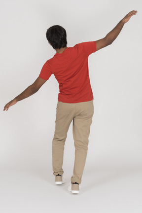 Back view of young man balancing