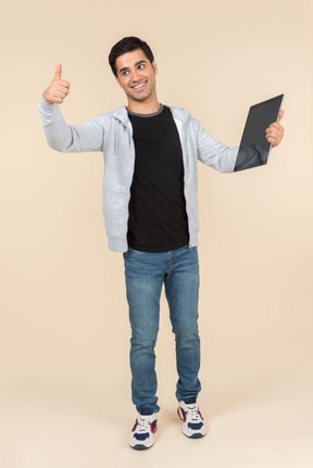 Young caucasian man holding a digital tablet