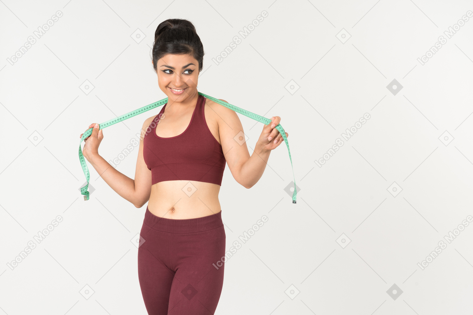 Young indian woman in sporstwear standing with cloth ruler on her neck