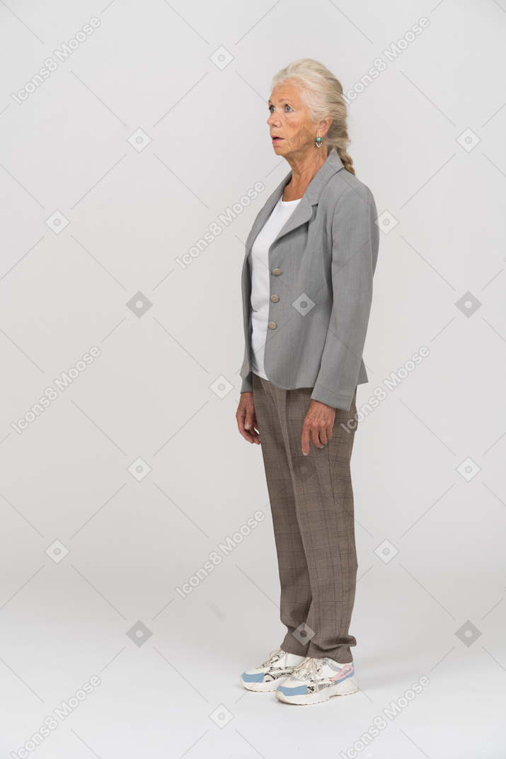 Side view of an impressed old woman in suit
