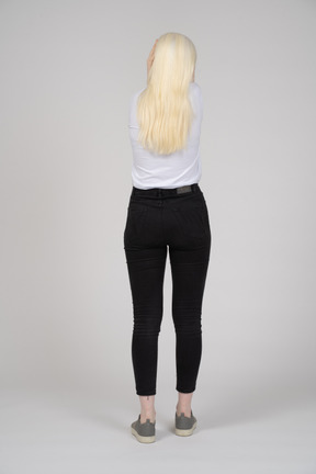 Back view of a long-haired woman standing