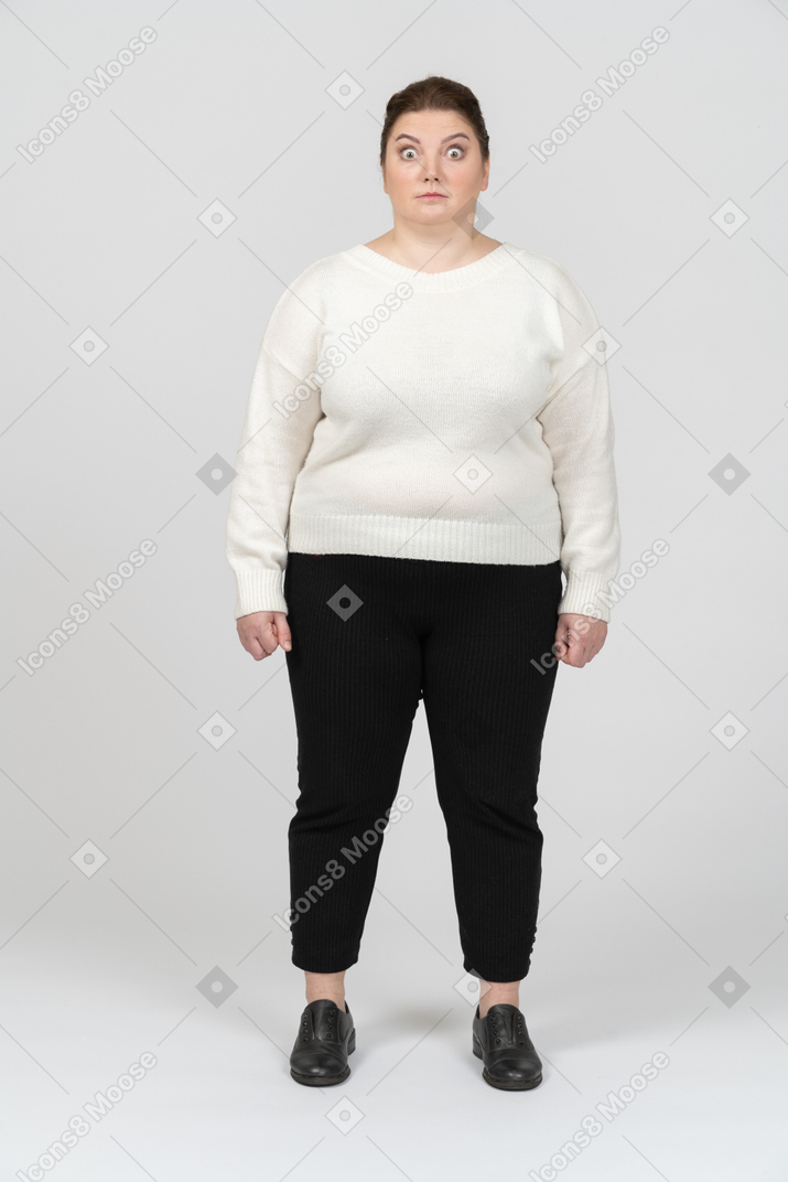 Plump woman in casual clothes making funny face
