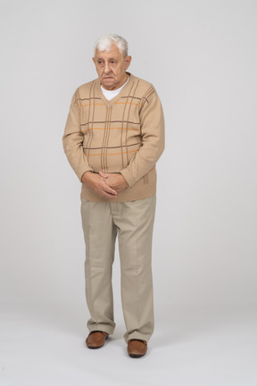 Front view of an old man in casual clothes standing still