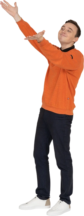Young man in orange sweatshirt standing