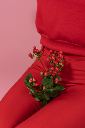 Red flowers between female`s legs