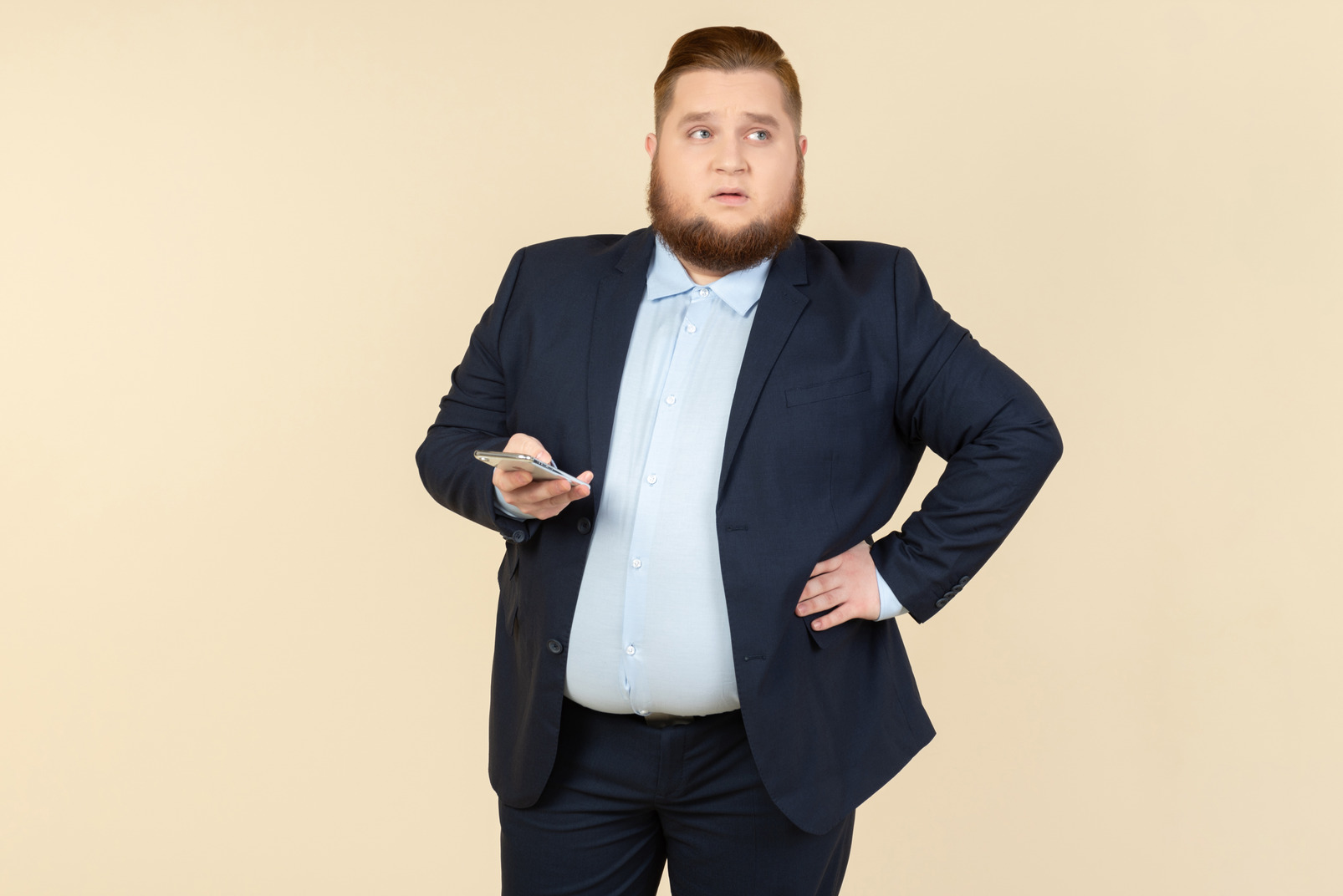Pensive young overweight office worker holding phone