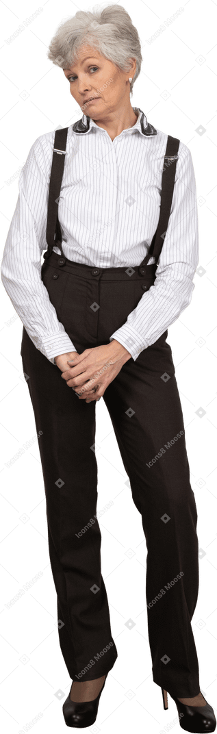 Front view of a displeased old lady in office clothing holding hands together
