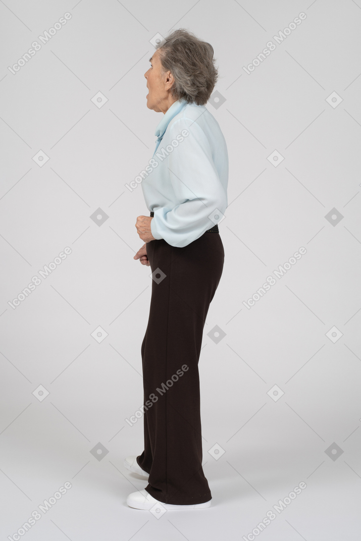 Side view of an old woman looking terrified