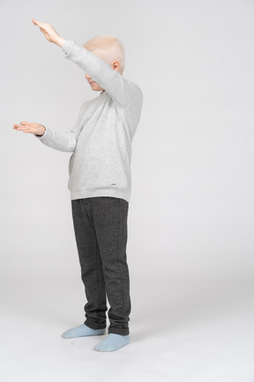 Boy showing size of something with his hands