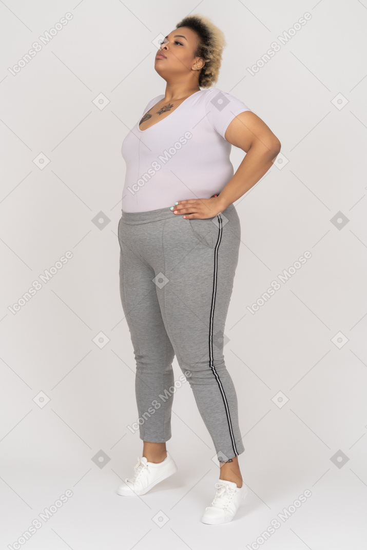 African-american female standing on tiptoes with her arms akimbo