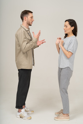 Side view of young couple speaking to each other