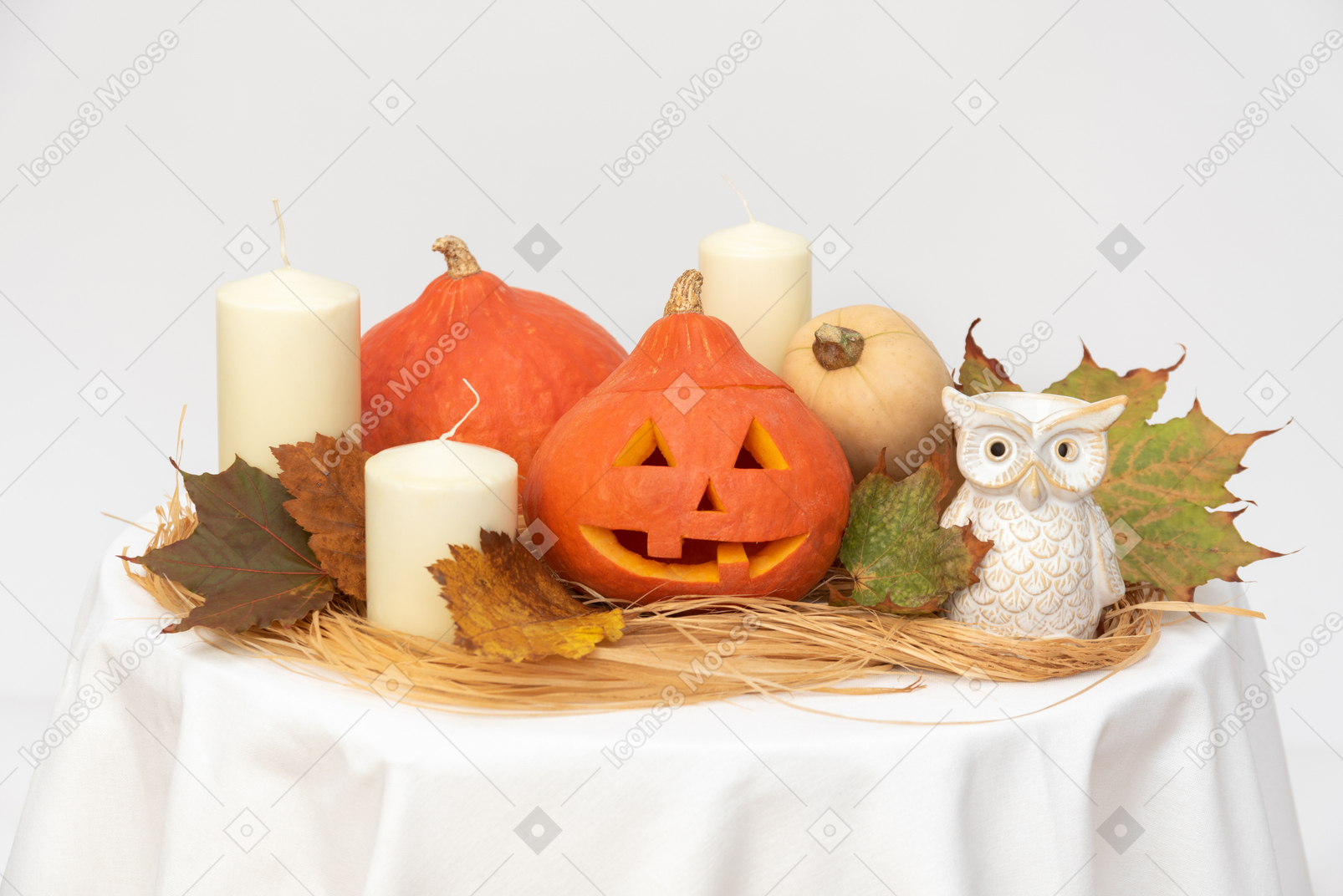 Carved pumpkins, yellow leaves, candles and owl figure