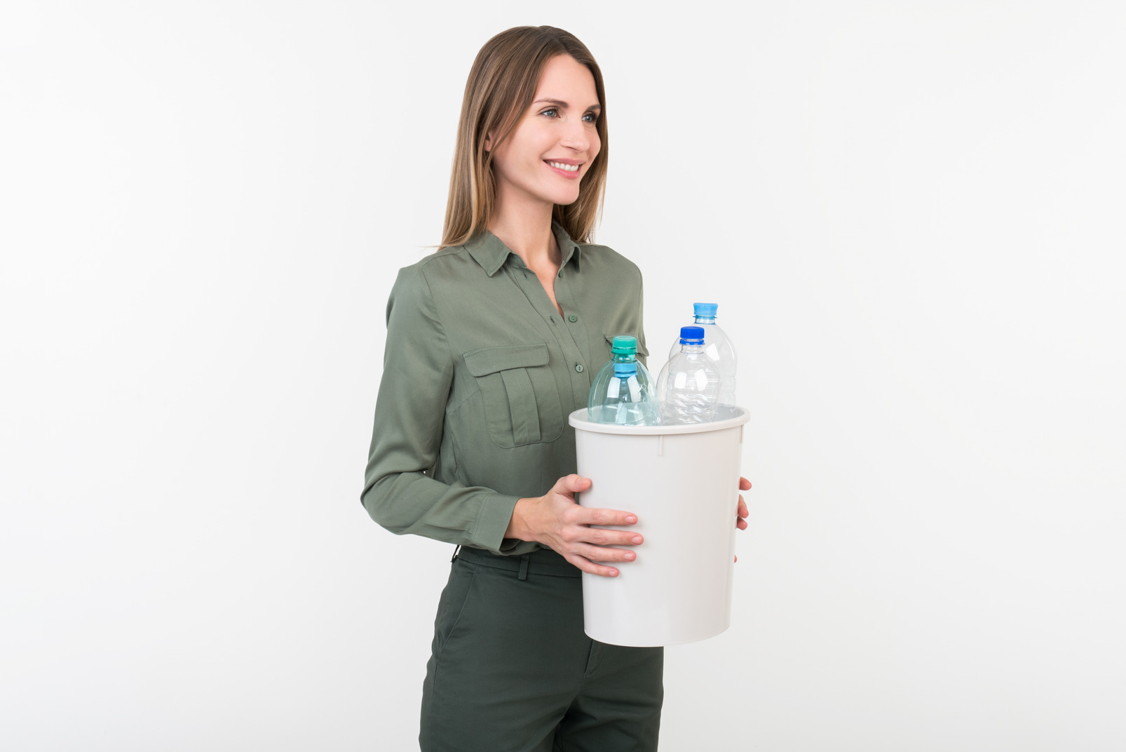 Young woman holding a waste-bin with plastic bottles