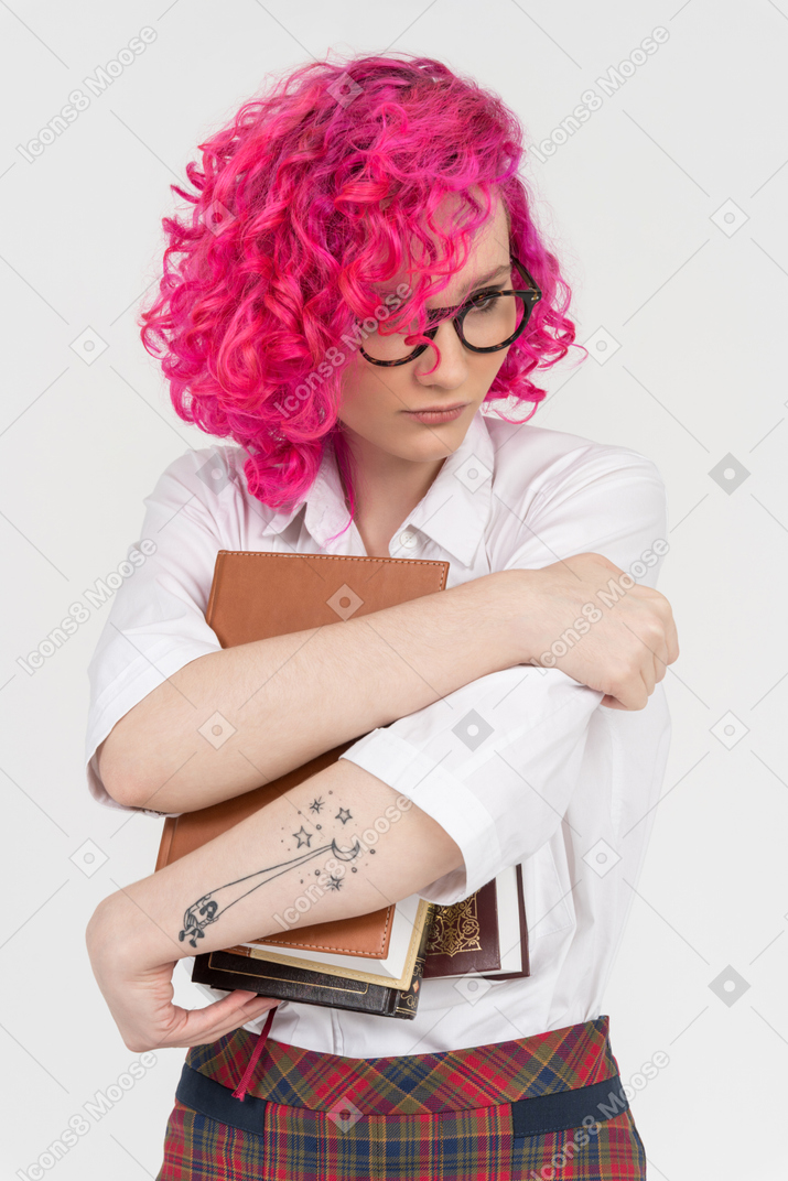 Beautiful teenage girl holding books