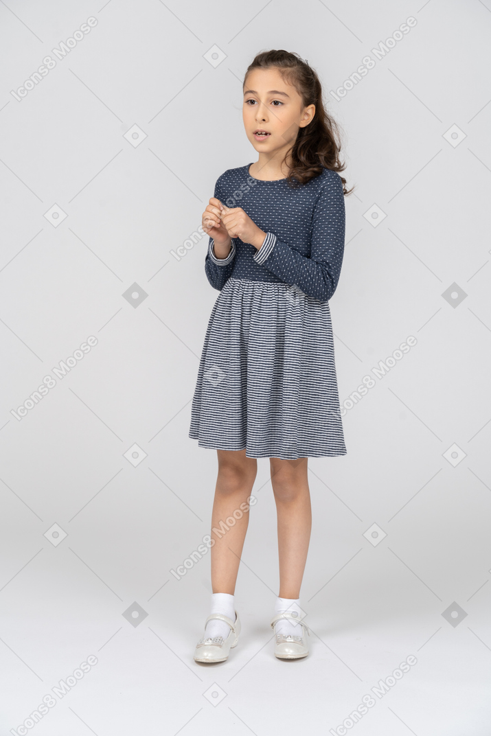 Front view of a girl fiddling with her fingers nervously