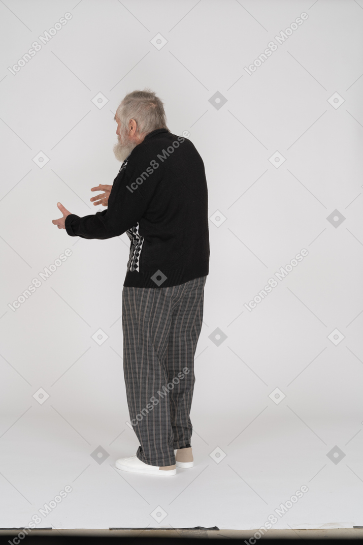 Back view of senior man gesturing