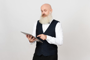 Aged man centred on using ipad