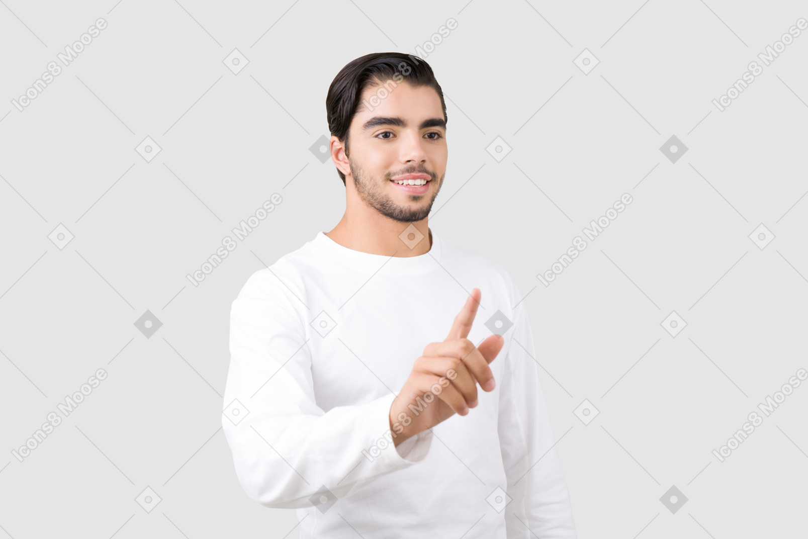 Handsome young man with light smile pointing at something