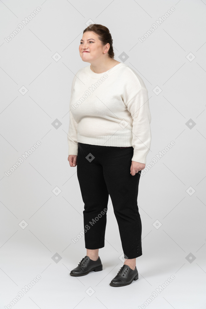 Plump woman in casual clothes making funny face