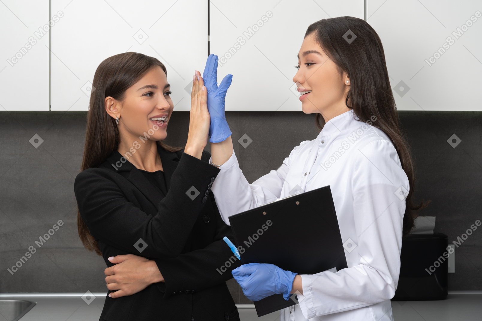 Cheerful patient and doctor giving a high-five