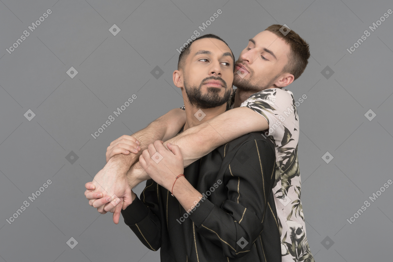 Young caucasian man hanging on the back of another man loosely