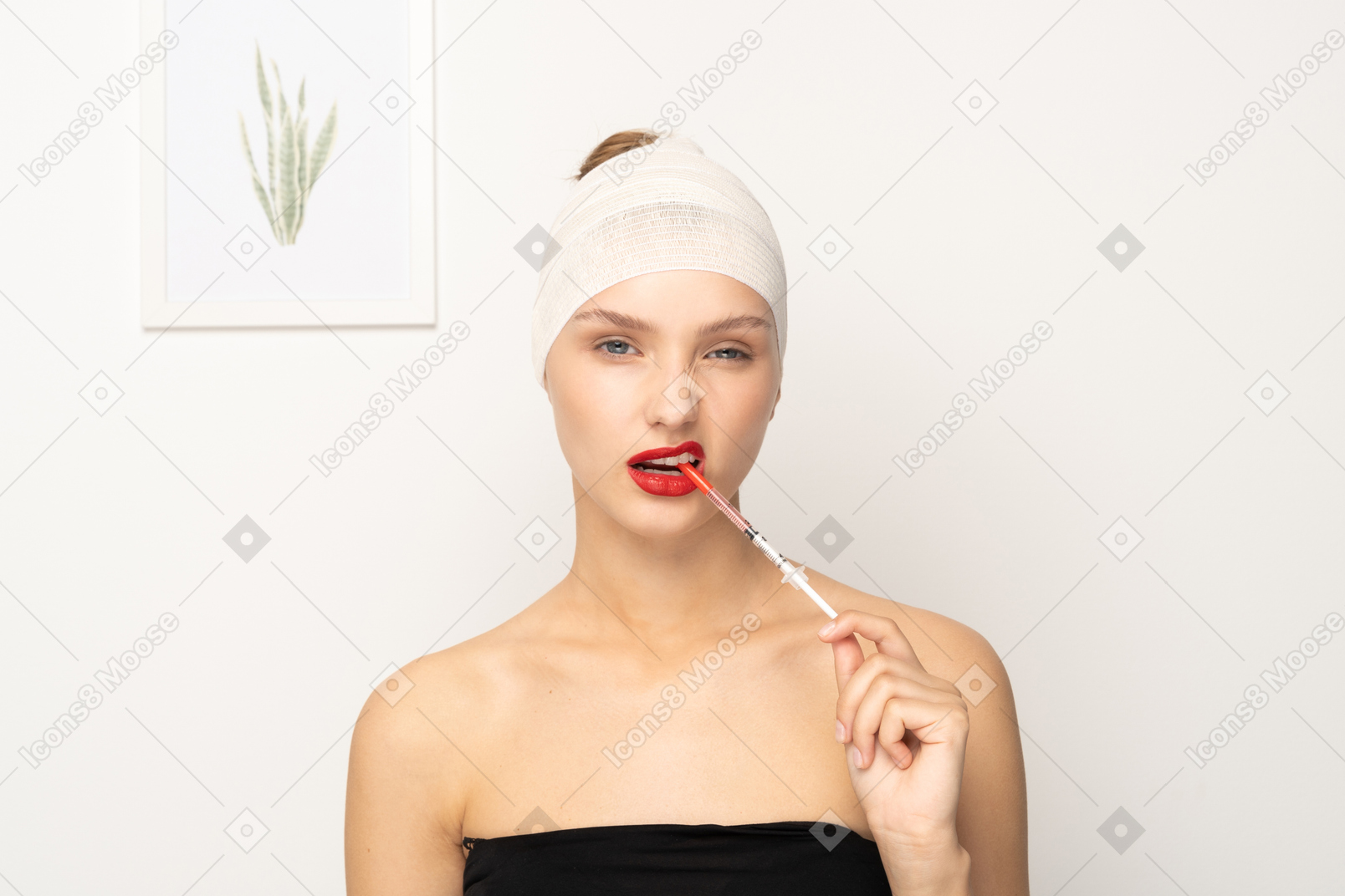 Portrait of a young woman biting syringe
