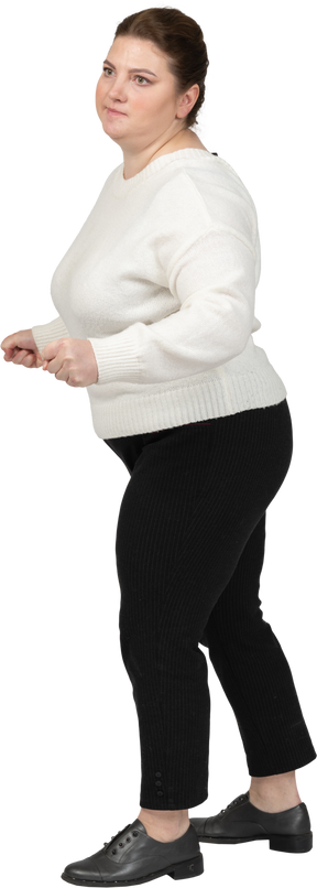 Plump woman in casual clothes dancing
