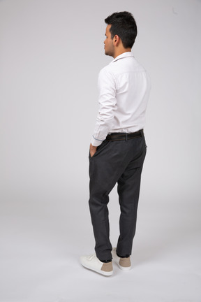 Back view of a man in a white shirt and black pants
