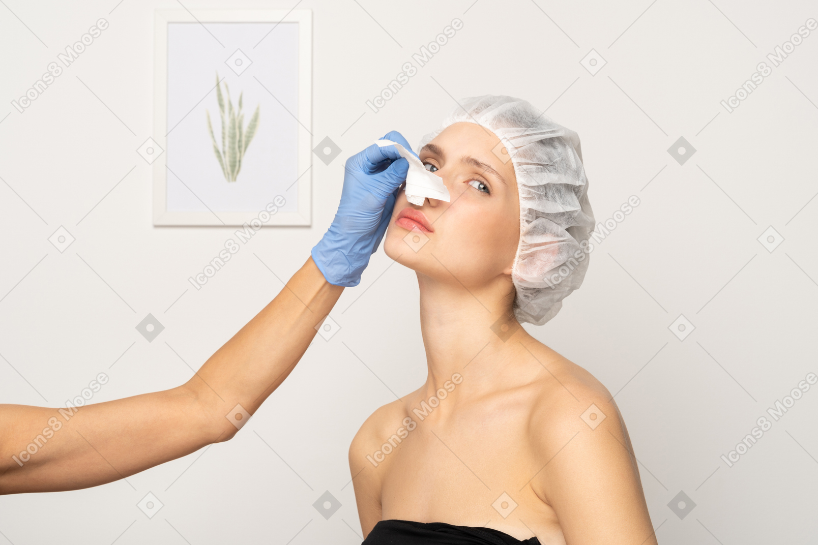 Doctor removing medical plaster from woman's nose