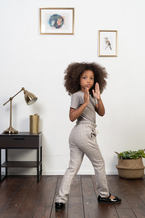 Good looking girl kid posing on the apartment background