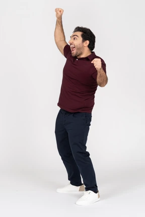 A cheering young man wearing casual clothes