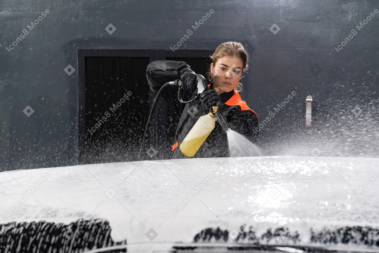 Young woman washing car