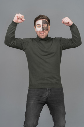 Front view of a male football fan clenching fists