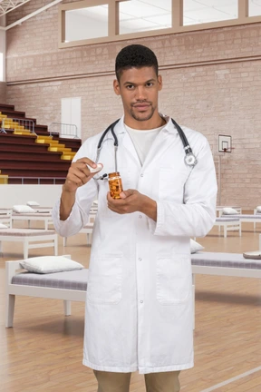 A man in a white lab coat holding a bottle of medicine