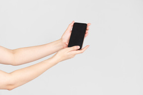 Female hands holding smartphone