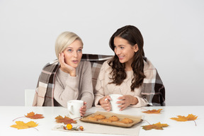 Young women drinking coffee and chatting