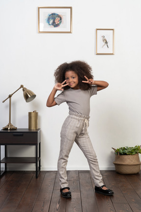 Good looking girl kid posing on the apartment background