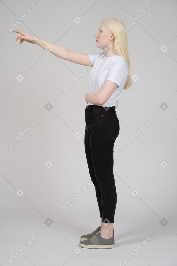 Blonde woman pointing upwards