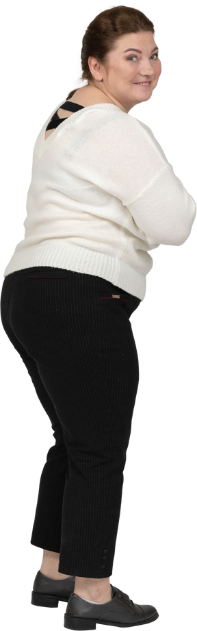 Rear view of a happy plump woman in casual clothes