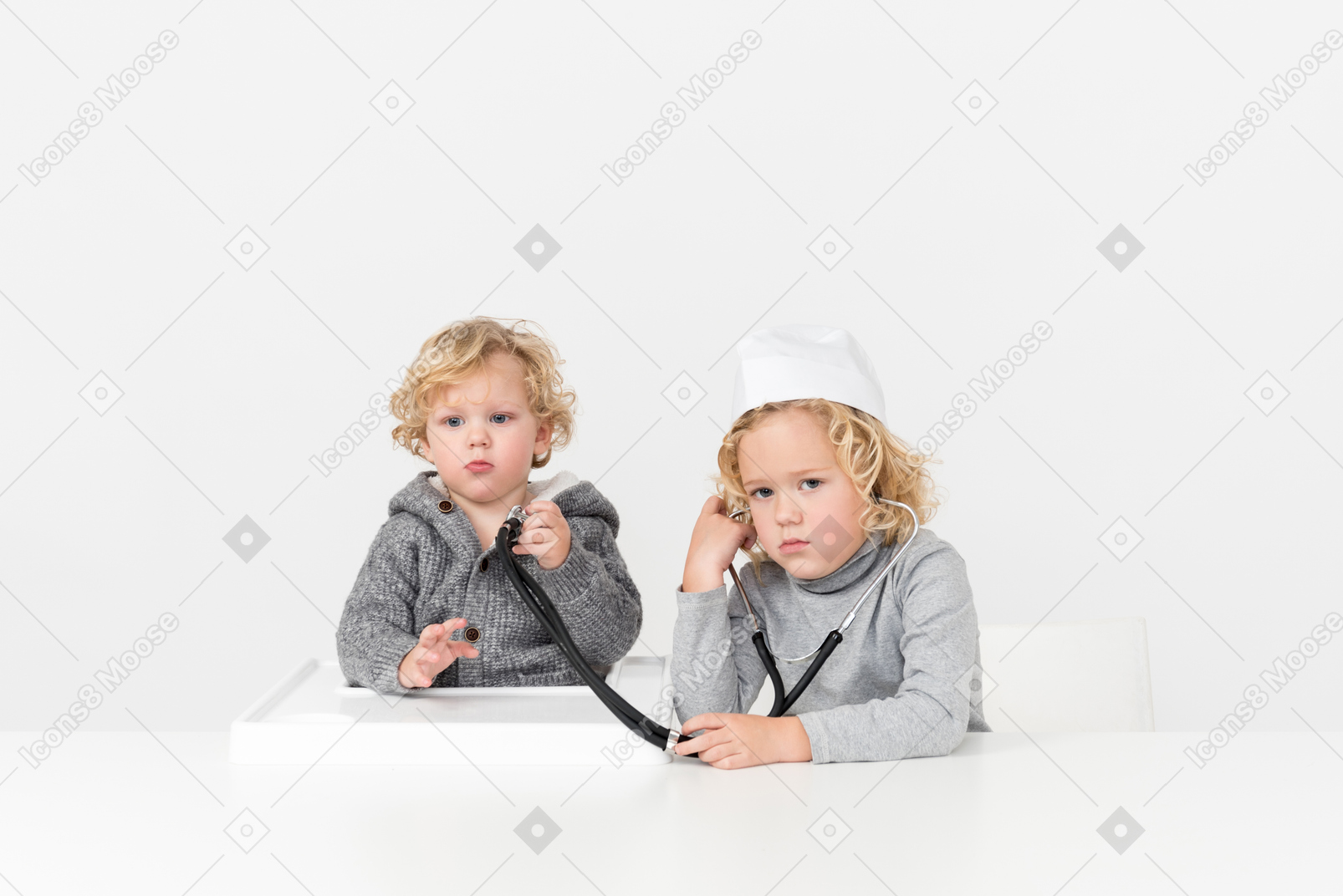 Brothers playing doctor with stethoscope