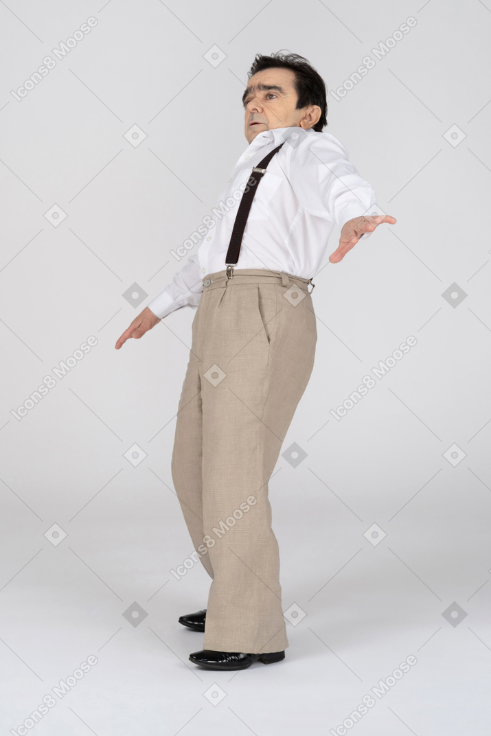 Middle-aged man falling backwards with spread hands