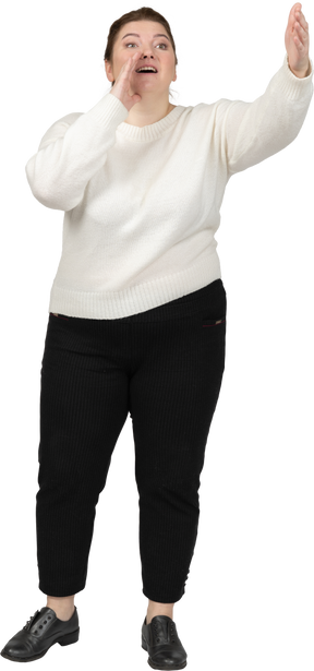 Front view of a plump woman in casual clothes calling someone