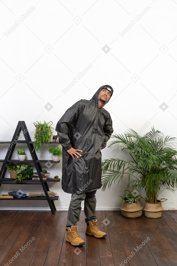 Man in raincoat looking up