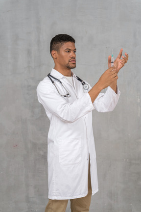 Male doctor preparing a syringe