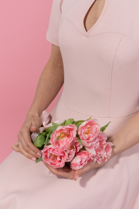 A female holding a flower bouquet